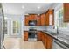 Kitchen showcases stainless steel appliances, granite counters, wood cabinets and ample natural light at 11 Glen Valley Ct, Angier, NC 27501