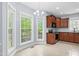 Bright kitchen boasts tile floors, wood cabinets and multiple windows offering lots of natural light at 11 Glen Valley Ct, Angier, NC 27501