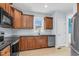 Updated kitchen features wood cabinetry, stainless appliances and a view into the dining area at 11 Glen Valley Ct, Angier, NC 27501