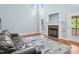 Spacious living room features a fireplace, hardwood floors, and a large window with natural light at 11 Glen Valley Ct, Angier, NC 27501