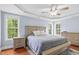 Bright main bedroom features a tray ceiling, ceiling fan and multiple windows providing plenty of light at 11 Glen Valley Ct, Angier, NC 27501