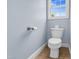 A half bathroom with a toilet with ceramic tile flooring and blue painted walls at 11 Glen Valley Ct, Angier, NC 27501