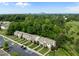 Aerial view of suburban townhomes surrounded by lush trees and near the city skyline at 1109 Renewal Pl, Raleigh, NC 27603