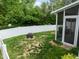 Fenced backyard with a fire pit and leads to a screened-in porch at 1109 Renewal Pl, Raleigh, NC 27603