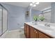 Bathroom with double sink vanity, plant, toilet, and glass-door shower at 1109 Renewal Pl, Raleigh, NC 27603