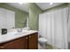 Bathroom vanity with sink, mirror, toilet, and shower with white curtain at 1109 Renewal Pl, Raleigh, NC 27603