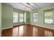 A brightly lit dining room features hardwood floors, three windows, and neutral paint at 1109 Renewal Pl, Raleigh, NC 27603