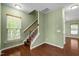 Foyer area has wooden stair case, neutral paint, hardwood floors, and natural light at 1109 Renewal Pl, Raleigh, NC 27603