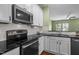 A well-appointed kitchen has stainless steel appliances, white cabinets and subway tile backsplash at 1109 Renewal Pl, Raleigh, NC 27603