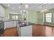 The eat-in kitchen boasts stainless steel appliances, white cabinets, and an island at 1109 Renewal Pl, Raleigh, NC 27603