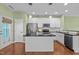 An eat-in kitchen features stainless steel appliances, white cabinets, and an island at 1109 Renewal Pl, Raleigh, NC 27603