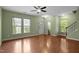 Bright living area featuring a ceiling fan, hardwood floors, and convenient access to a half bath at 1109 Renewal Pl, Raleigh, NC 27603