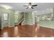 Open-concept living area with hardwood floors, a staircase, and plenty of natural light at 1109 Renewal Pl, Raleigh, NC 27603