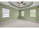 A large main bedroom features plush carpet, and tray ceilings at 1109 Renewal Pl, Raleigh, NC 27603