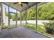 Interior of a screened porch overlooking a fenced backyard with a fire pit at 1109 Renewal Pl, Raleigh, NC 27603