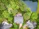 A birds-eye view of a house with beautiful backyard deck, pond and lush green foliage at 111 Murdock Creek Ct, Cary, NC 27519