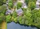 Aerial view showcases the neighborhood with mature trees, a pond, and private backyards at 111 Murdock Creek Ct, Cary, NC 27519