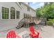 Relax on the deck with red Adirondack chairs, and stairs to backyard at 111 Murdock Creek Ct, Cary, NC 27519