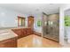 Elegant bathroom showcasing dual vanities, bathtub, and a unique glass shower at 111 Murdock Creek Ct, Cary, NC 27519