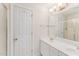 Bright bathroom featuring double sinks, a large mirror, and a glass-enclosed shower at 111 Murdock Creek Ct, Cary, NC 27519