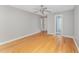 Bedroom features hardwood flooring, neutral paint, and two open doorways at 111 Murdock Creek Ct, Cary, NC 27519