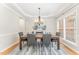 Formal dining room featuring hardwood floors, area rug, and stylish chandelier at 111 Murdock Creek Ct, Cary, NC 27519