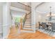 Grand foyer featuring hardwood floors, elegant staircase, and open view to living and dining spaces at 111 Murdock Creek Ct, Cary, NC 27519
