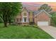 Charming brick home with manicured lawn, mature trees, and inviting front entrance at 111 Murdock Creek Ct, Cary, NC 27519