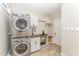 Convenient laundry room with stacked washer/dryer and custom cabinetry at 111 Murdock Creek Ct, Cary, NC 27519