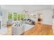 Bright living room boasts hardwood floors, large windows and an open layout into the kitchen at 111 Murdock Creek Ct, Cary, NC 27519