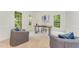 Well-lit home office with large windows, stylish desk, and comfortable seating at 111 Murdock Creek Ct, Cary, NC 27519