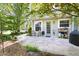 Charming back patio with stone pavers and outdoor seating, perfect for relaxing outdoors at 111 Sir Richard Ln, Chapel Hill, NC 27517