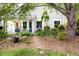 Beautifully landscaped backyard featuring a patio, seating area, and mature trees for shade and privacy at 111 Sir Richard Ln, Chapel Hill, NC 27517
