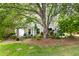 Spacious backyard featuring mature trees and landscaping, creating a serene outdoor setting at 111 Sir Richard Ln, Chapel Hill, NC 27517