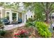 Charming backyard patio featuring a seating area surrounded by lush landscaping and colorful flowers at 111 Sir Richard Ln, Chapel Hill, NC 27517