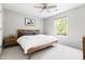 Bright bedroom with a wooden frame bed, neutral walls, a ceiling fan, and a large window overlooking trees at 111 Sir Richard Ln, Chapel Hill, NC 27517