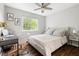 Comfortable bedroom with a desk, a chair, hardwood floors, a large window, and neutral walls with fern decor at 111 Sir Richard Ln, Chapel Hill, NC 27517