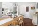 Open concept dining room with modern lighting and hardwood floors, with a view into the living room at 111 Sir Richard Ln, Chapel Hill, NC 27517