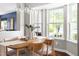 Dining room with bay windows, wood table, and view of outdoor greenery at 111 Sir Richard Ln, Chapel Hill, NC 27517