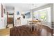 Bright dining area with modern lighting, wood floors, and a view into the kitchen at 111 Sir Richard Ln, Chapel Hill, NC 27517