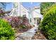Charming home exterior with lush landscaping, including vibrant azaleas and a welcoming walkway at 111 Sir Richard Ln, Chapel Hill, NC 27517