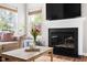 Cozy living room featuring a fireplace, hardwood floors, and comfortable seating, creating a warm and inviting atmosphere at 111 Sir Richard Ln, Chapel Hill, NC 27517