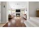 Bright living room featuring hardwood floors, a fireplace, and comfortable seating, creating a cozy atmosphere at 111 Sir Richard Ln, Chapel Hill, NC 27517