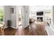 Inviting living room with hardwood floors, a cozy fireplace, and an open doorway to the outdoors at 111 Sir Richard Ln, Chapel Hill, NC 27517