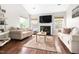 Comfortable living room with hardwood floors, a fireplace, and natural light, perfect for relaxing and entertaining at 111 Sir Richard Ln, Chapel Hill, NC 27517