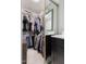 Organized walk-in closet with ample shelving, hanging space, and a vanity with a mirror, for your wardrobe at 111 Sir Richard Ln, Chapel Hill, NC 27517