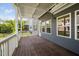 This covered back deck offers a view of the landscaped backyard and neighboring properties at 11808 Venture Oak Way, Raleigh, NC 27613