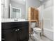 This bathroom includes tile floors and a wood storage unit over the toilet at 11808 Venture Oak Way, Raleigh, NC 27613