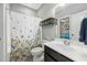 A full bathroom featuring a shower/tub combo and a sink with black vanity at 11808 Venture Oak Way, Raleigh, NC 27613