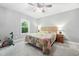 This bedroom features neutral walls, a patterned bedspread, and a ceiling fan at 11808 Venture Oak Way, Raleigh, NC 27613